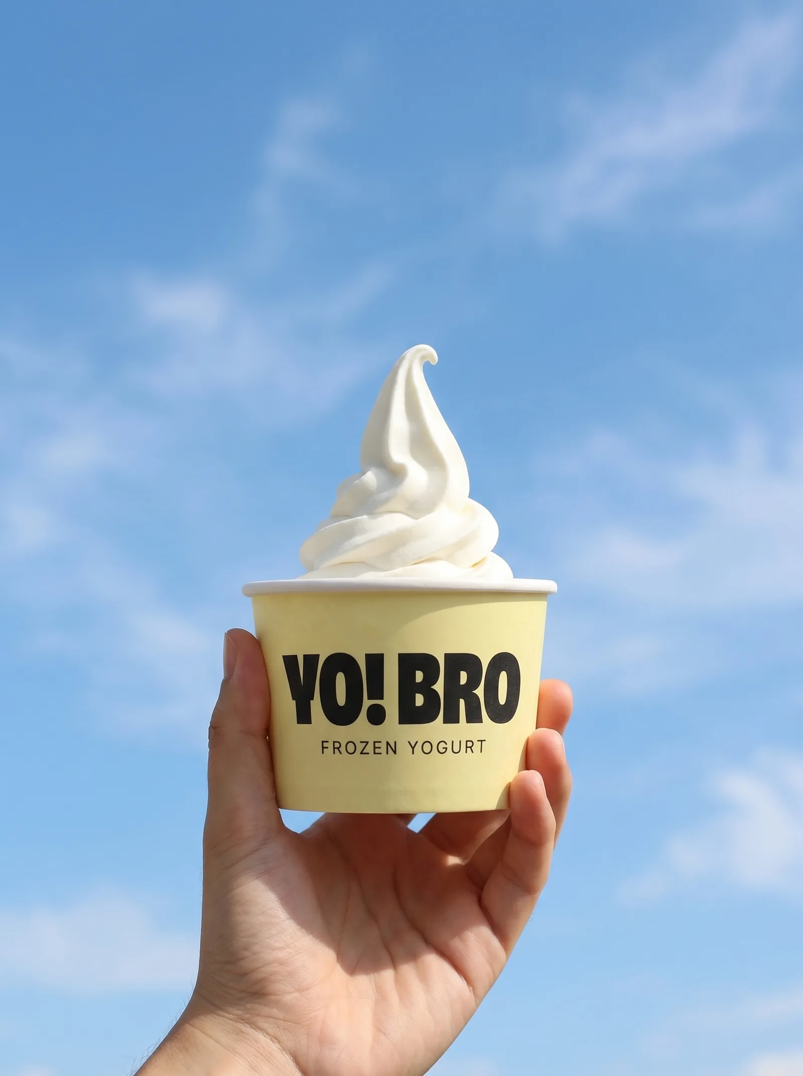 YO! BRO frozen yogurt cup against a blue sky
